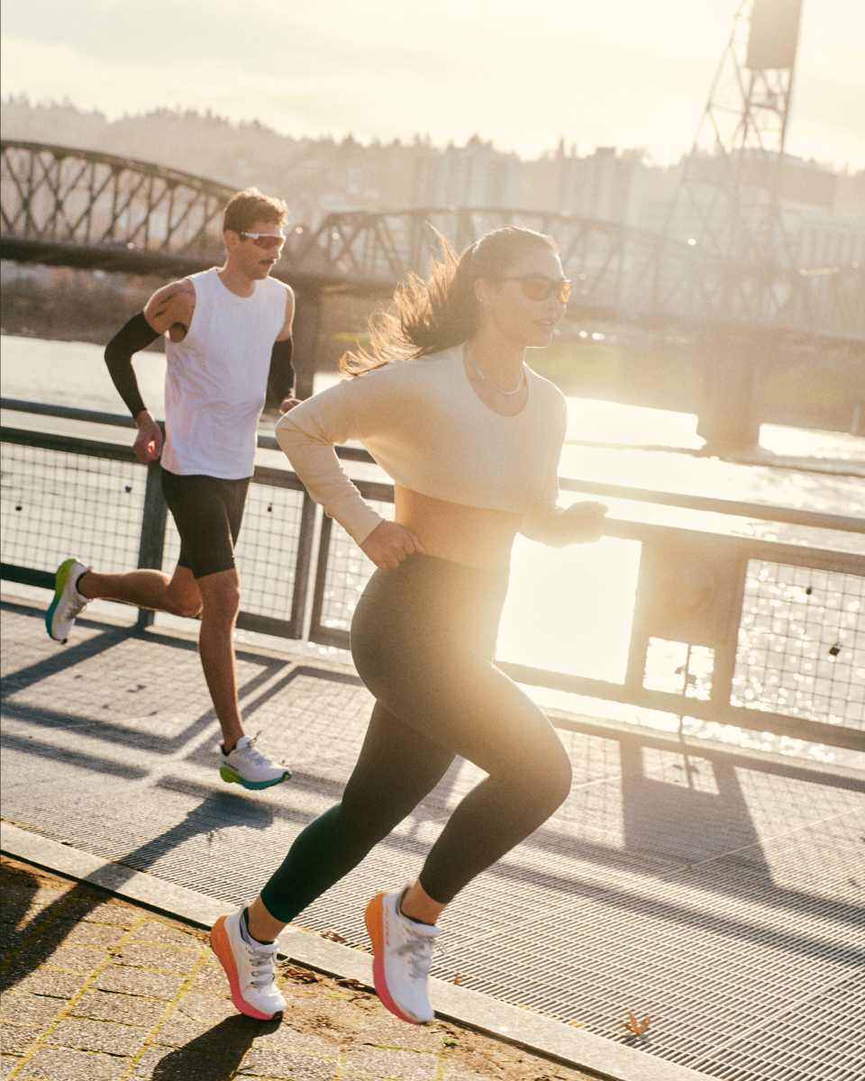 blurred image of someone running at night with a spotight on their lower legs